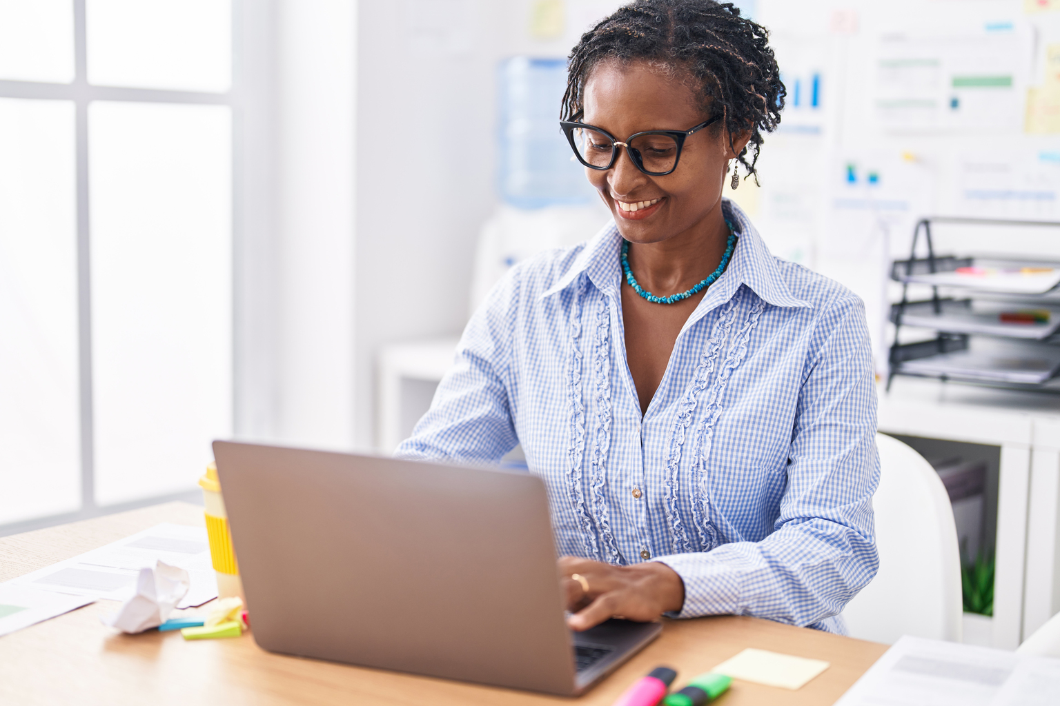 Middle age african american woman business worker using laptop working at office