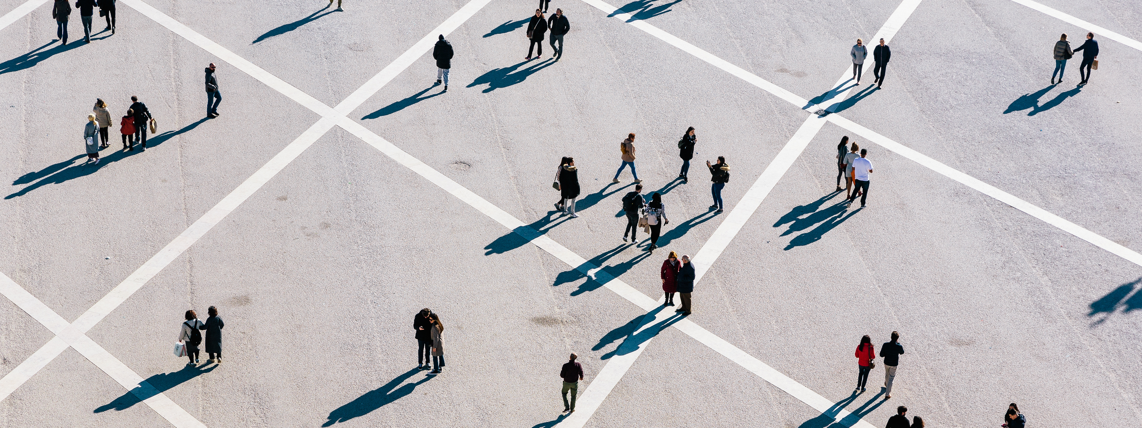 People walking at the town square on a sunny day