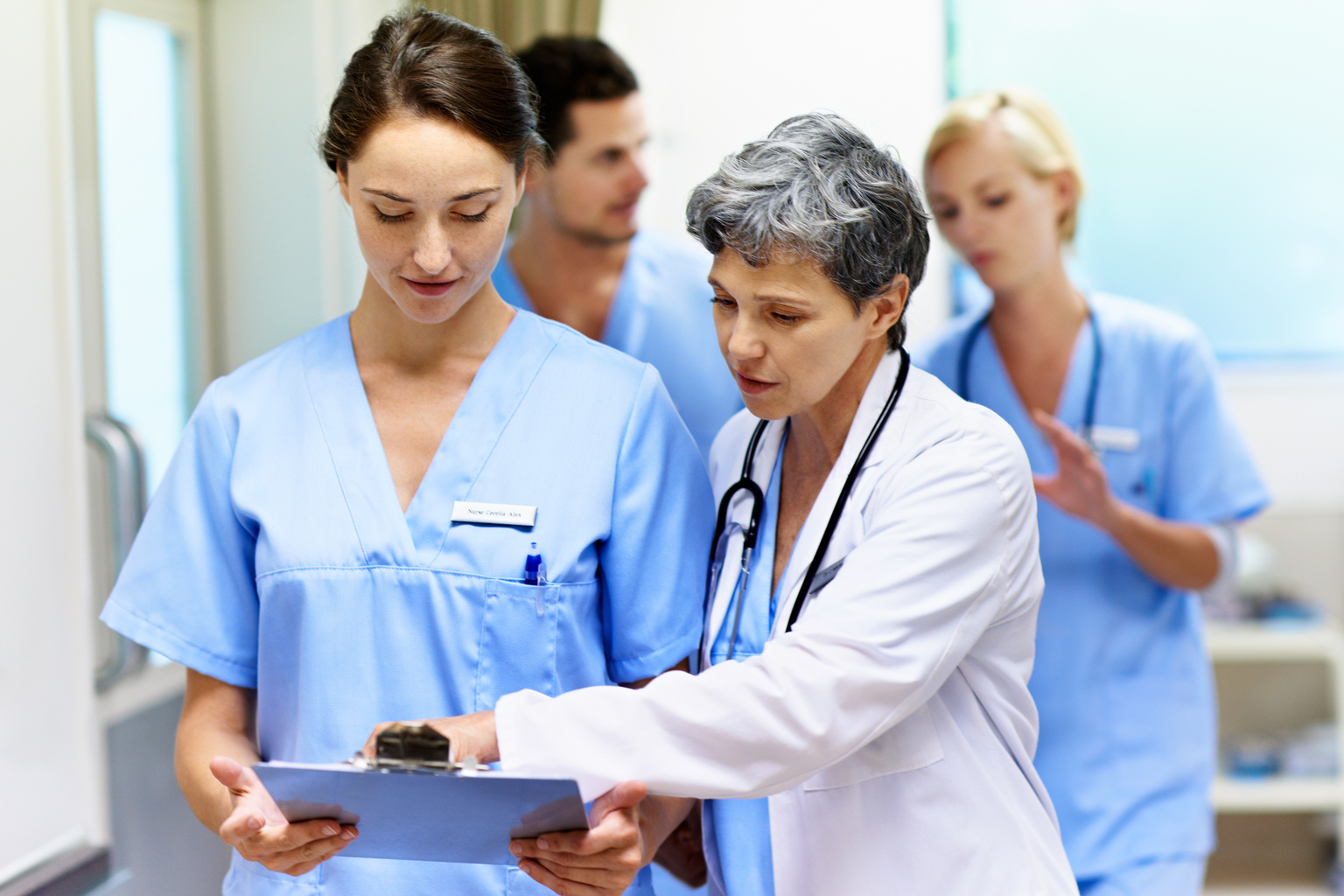 Female doctors walking and talking in a hospital corridor.