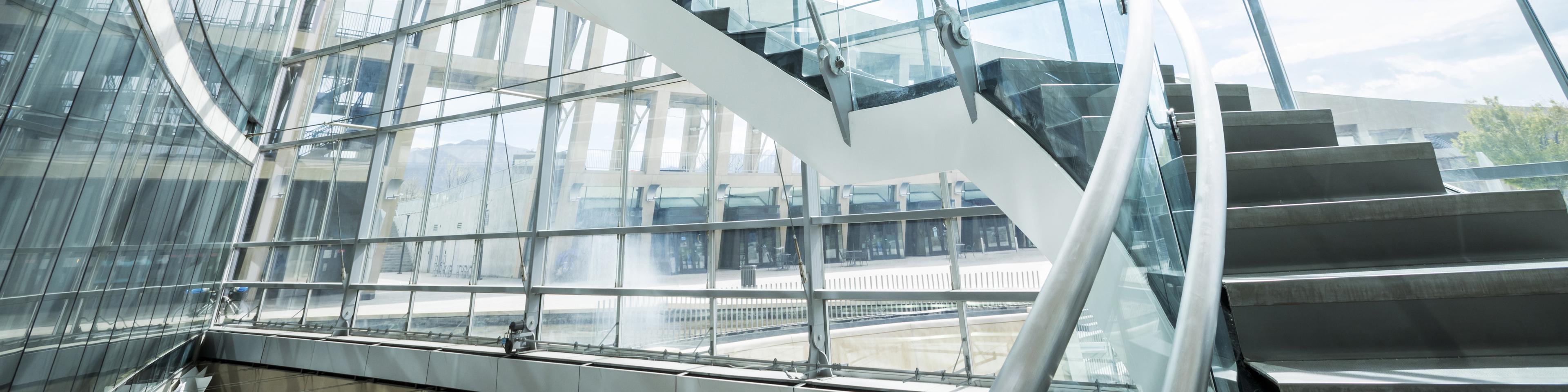 Distant Mixed Race business people standing on staircase and talking