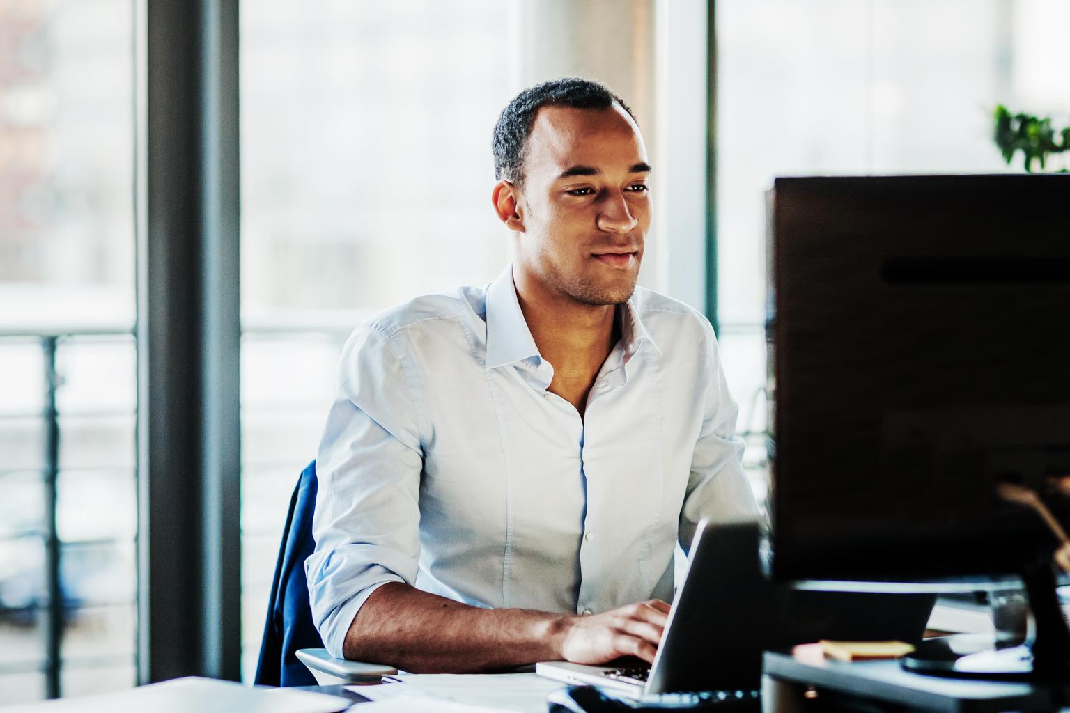 ffice Manager Working On Computer At His Desk