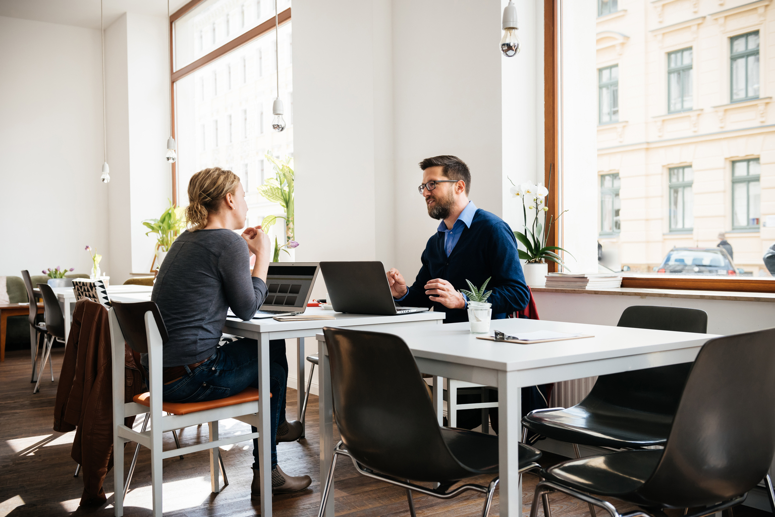 Two Business Associates Talking In Cafe