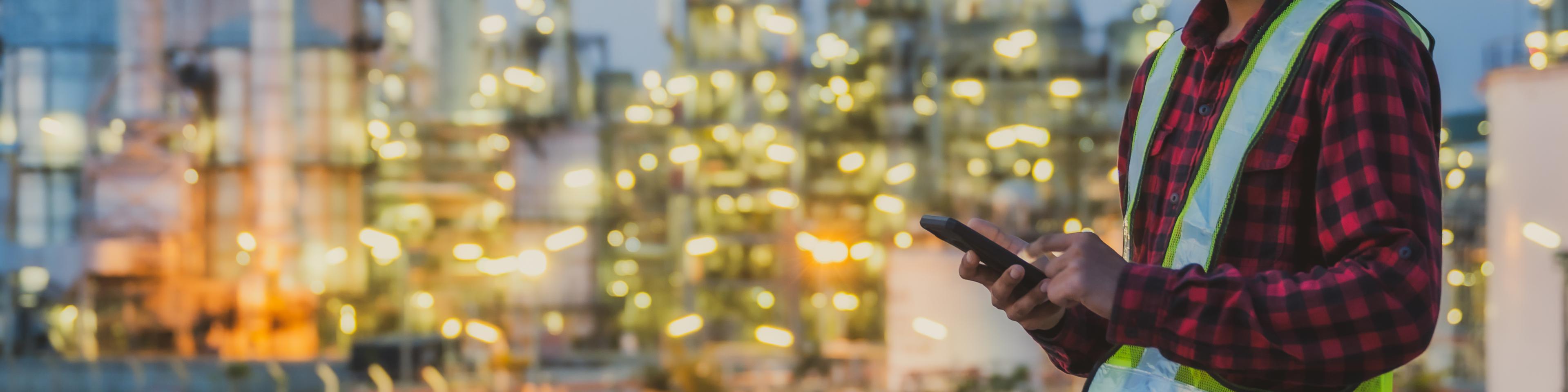 Asian man engineer working late night shift at petroleum oil refinery in industrial estate