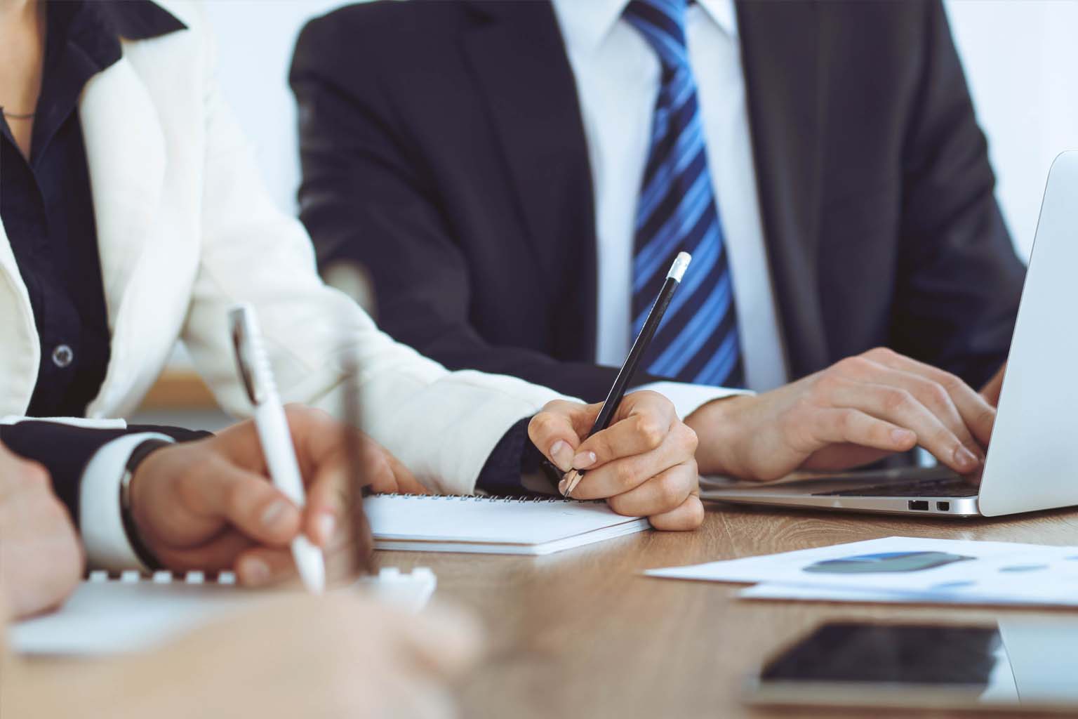 closeup of individuals in a business meeting