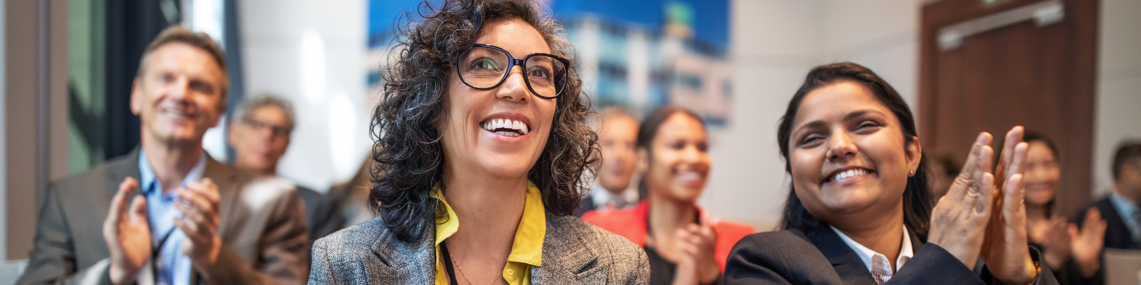 Professionals applauding in a launch event