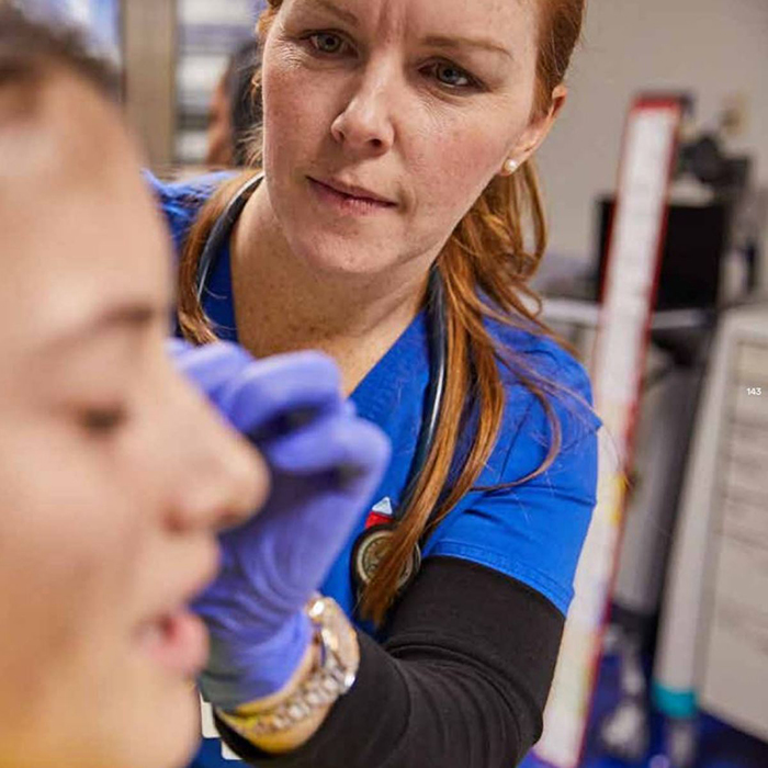 Nurse cleaning side of patient's face