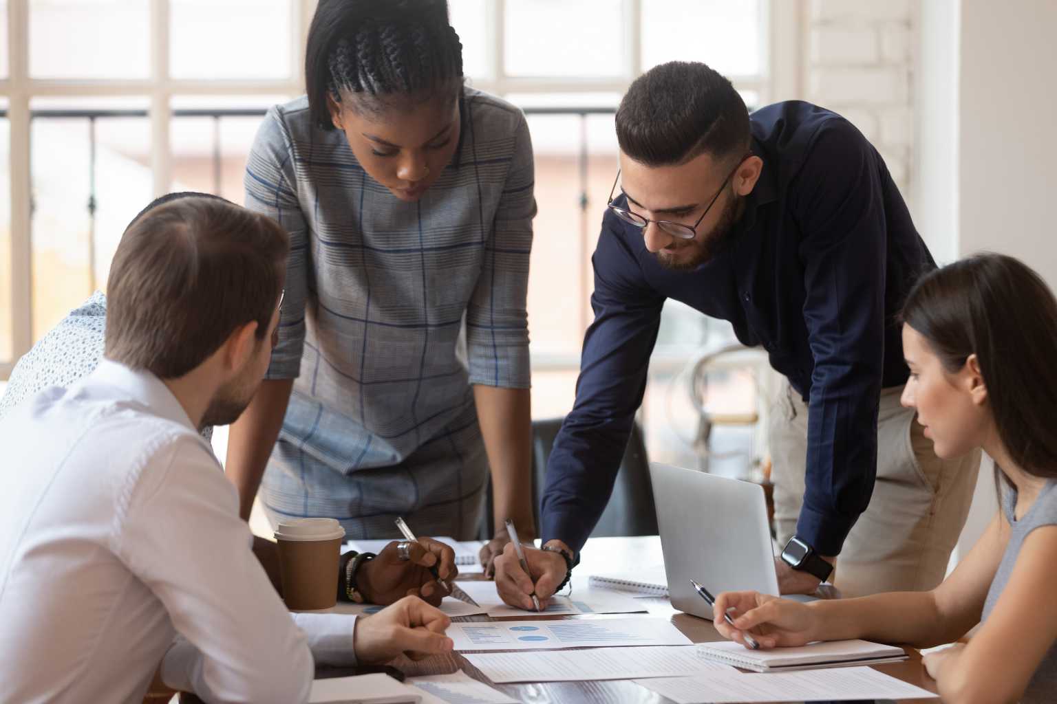 Group gathers around conference table