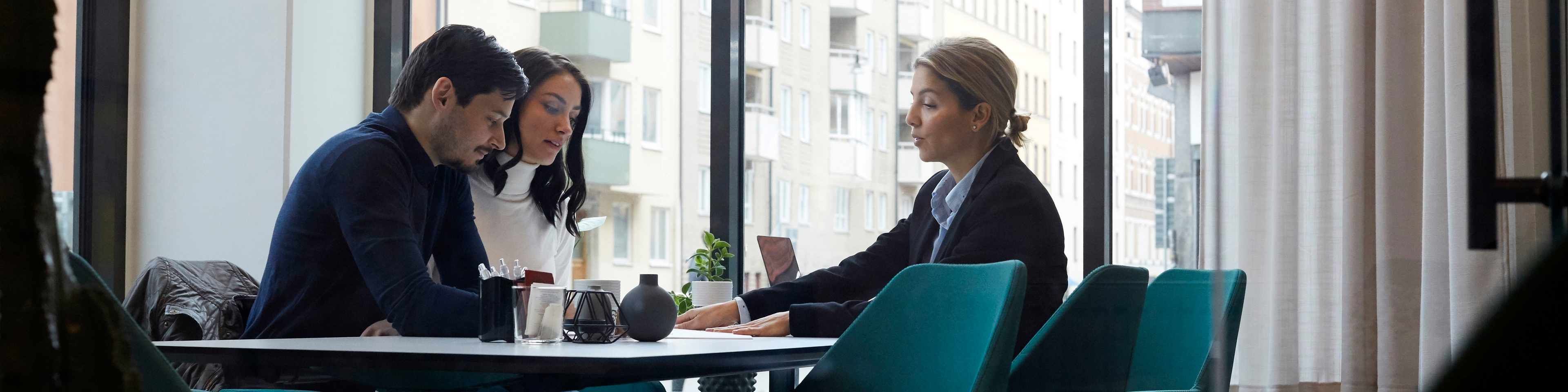 Real estate agent discussing with couple in office