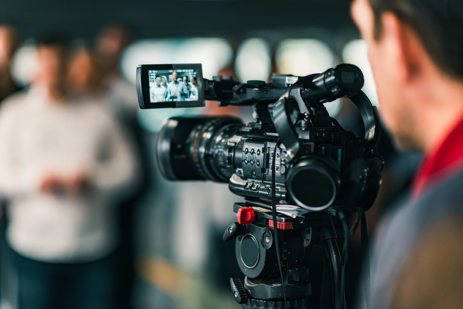 Close-Up Of Cameraman Filming In Studio