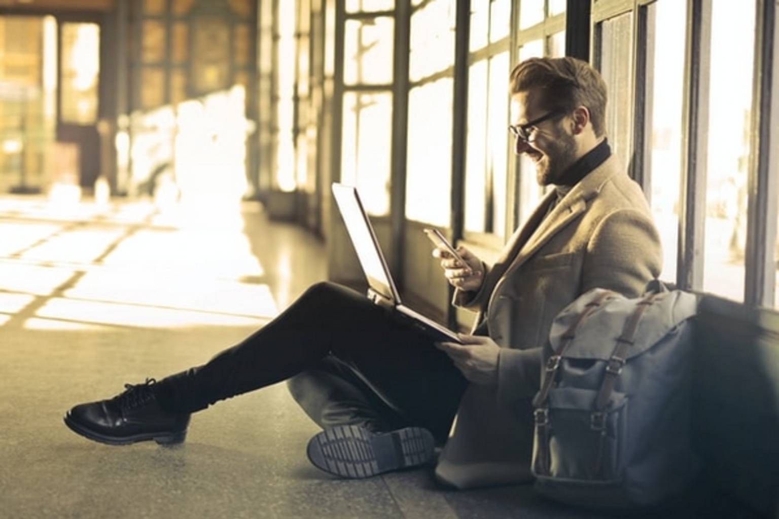 Man on laptop sat on floor