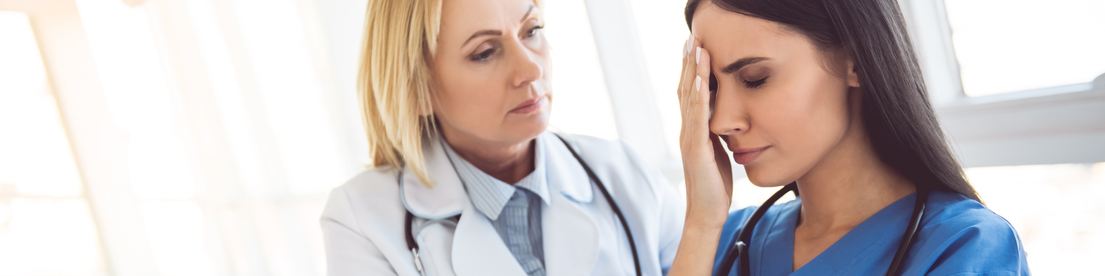 Female doctor consoling distraught nurse