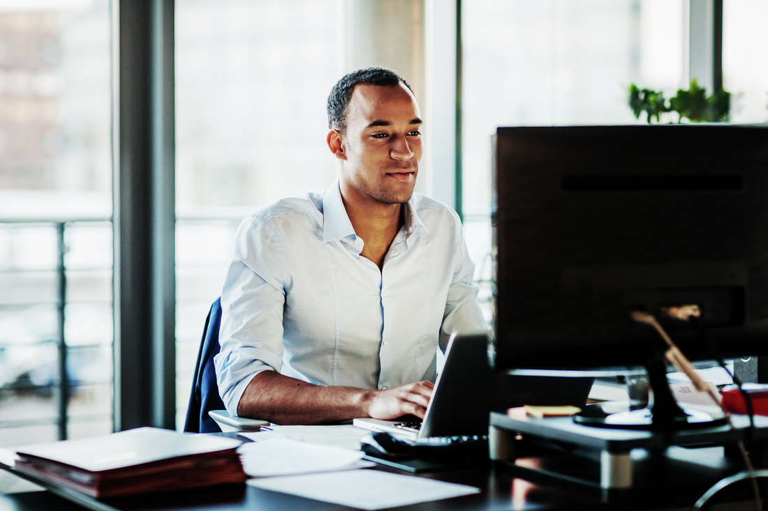 ffice Manager Working On Computer At His Desk