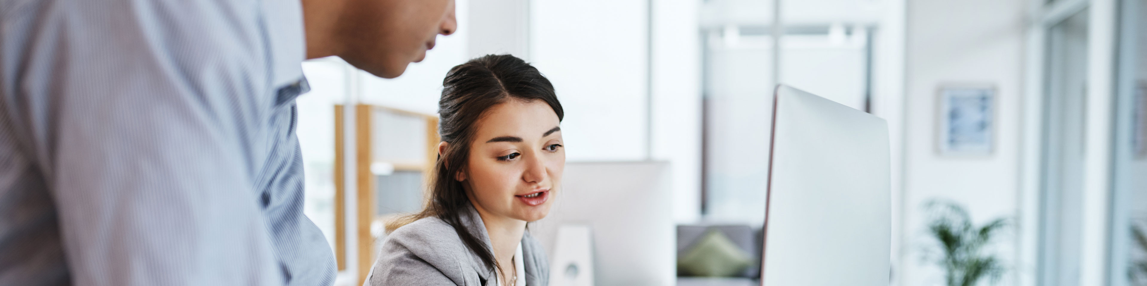 A businessman and businesswoman are discussing the need for a commercial registered agent