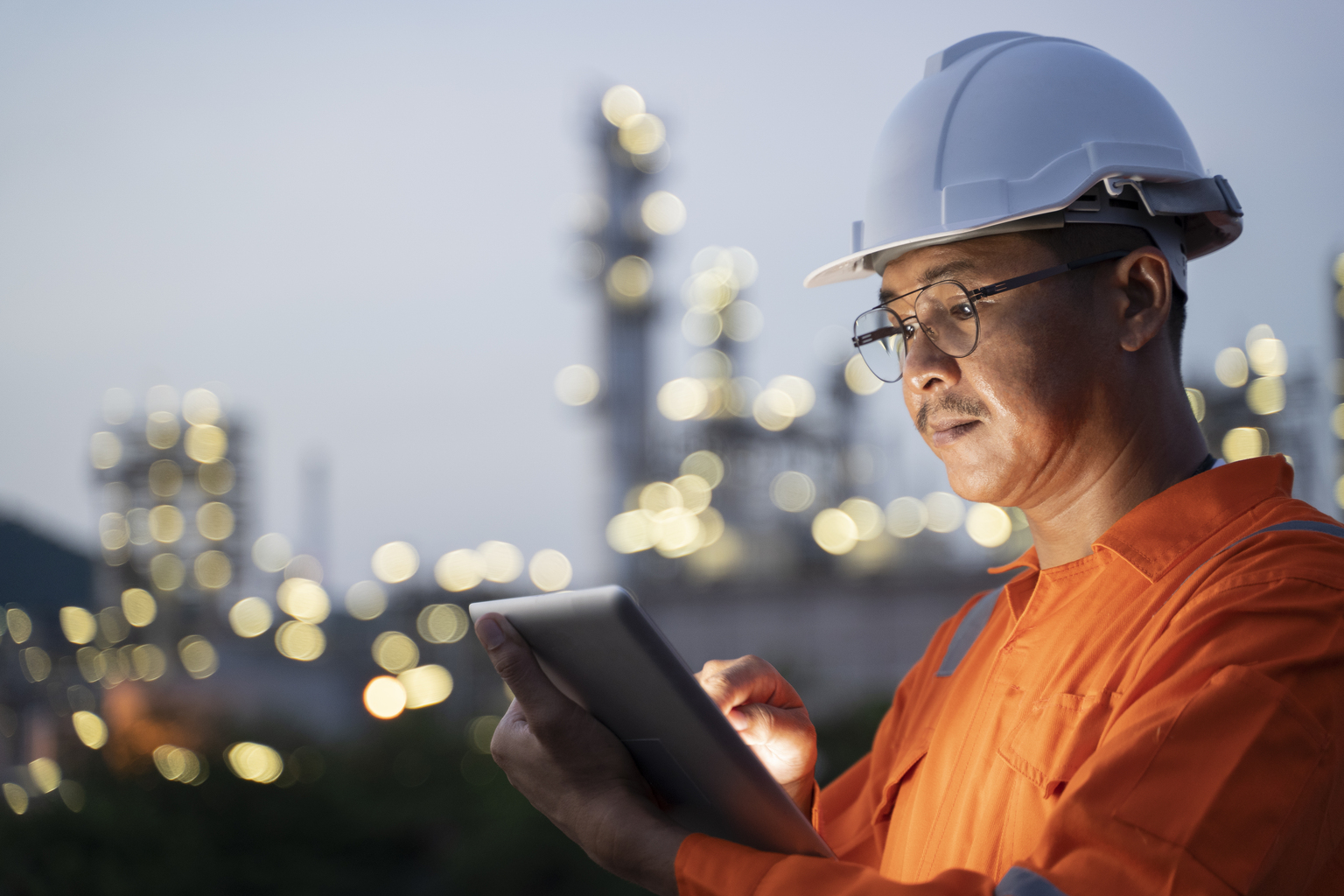 Engineer checks shipment of chemicals at oil and gas industry pipeline job site.