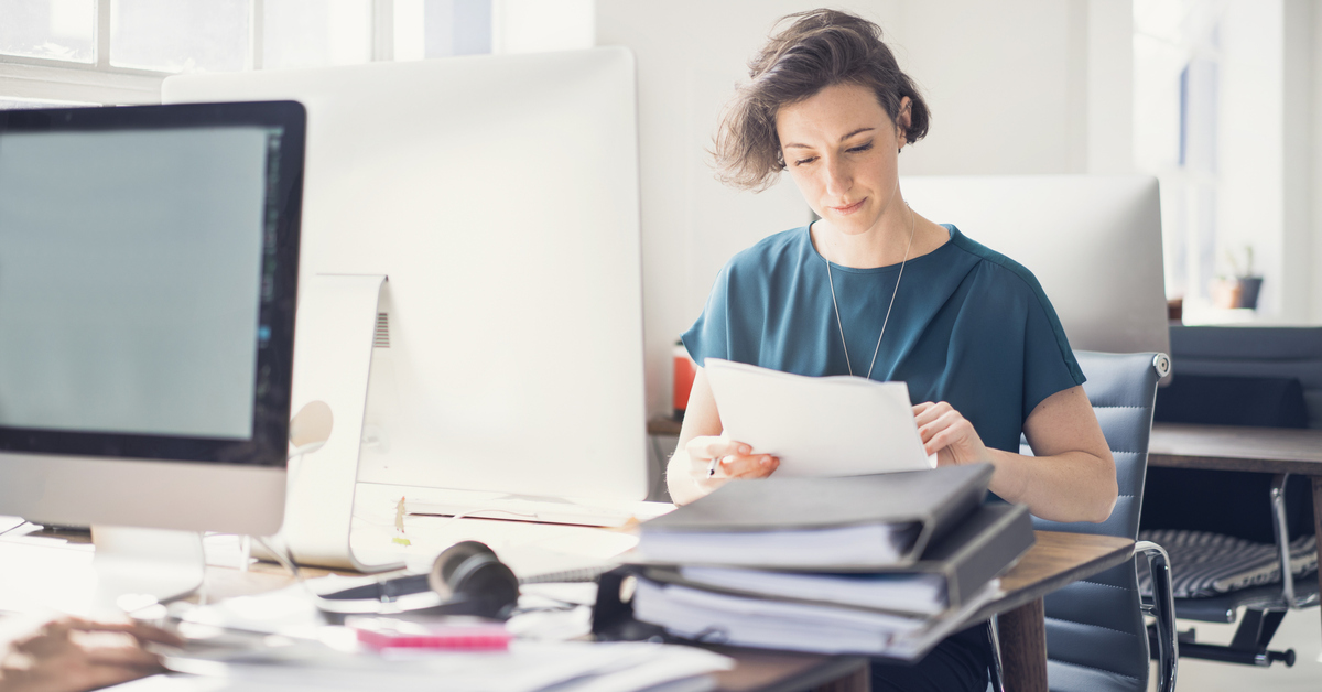 Businesswoman reviewing paperwork in office