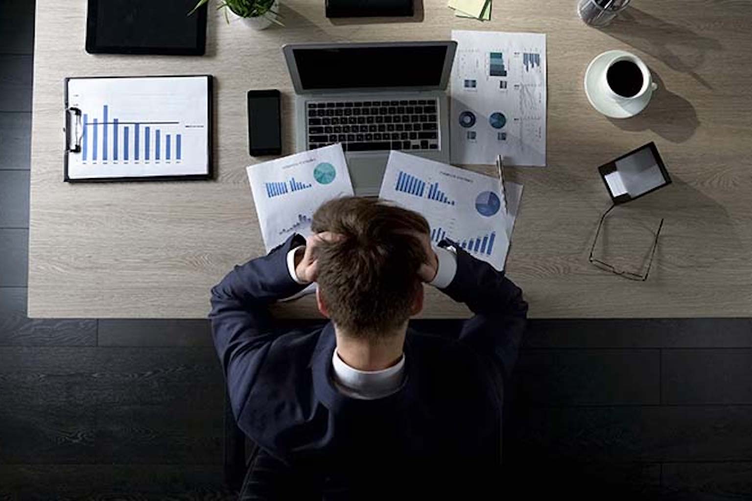 Man in front of desk and computer