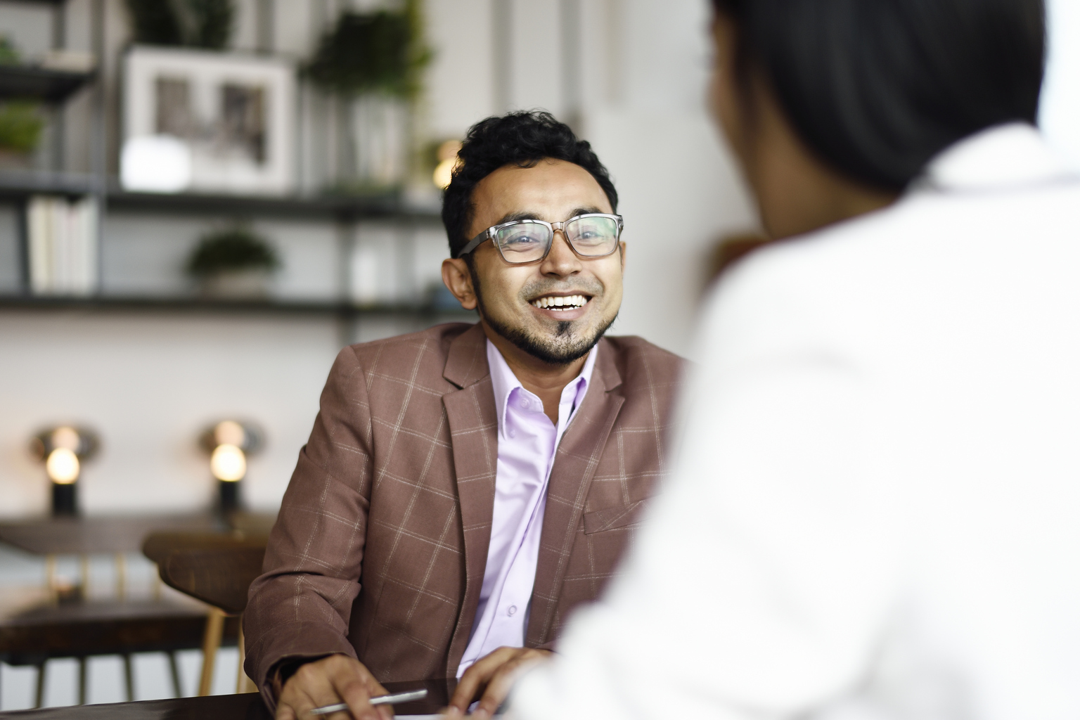 Man smiling and signing documents