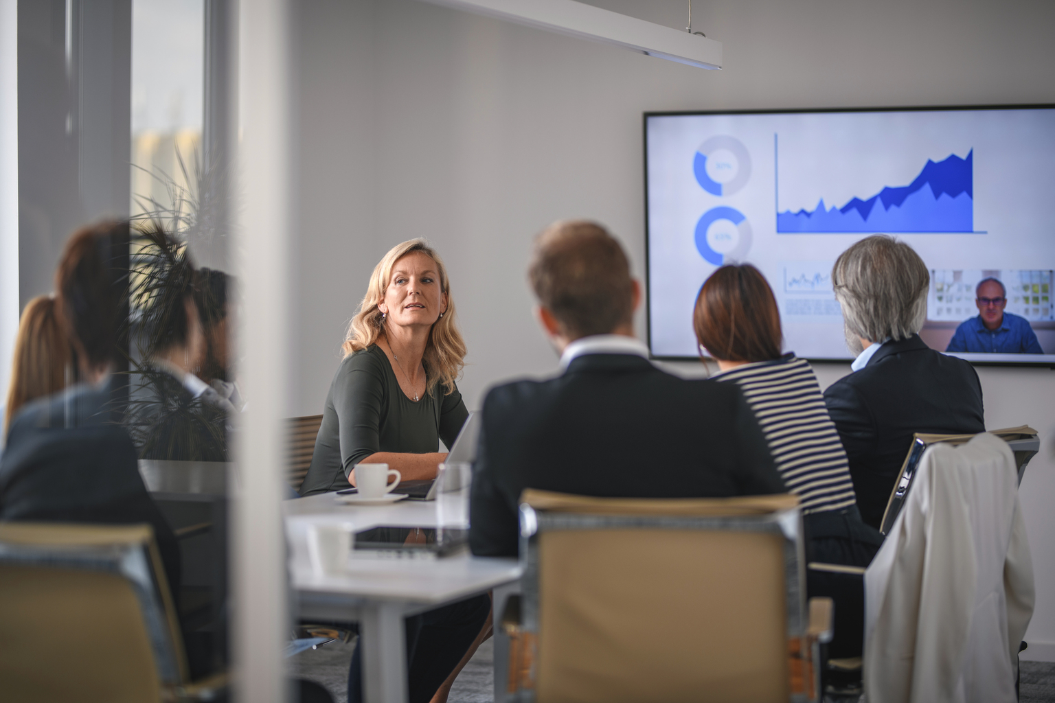 White businesswoman listening at business conference.