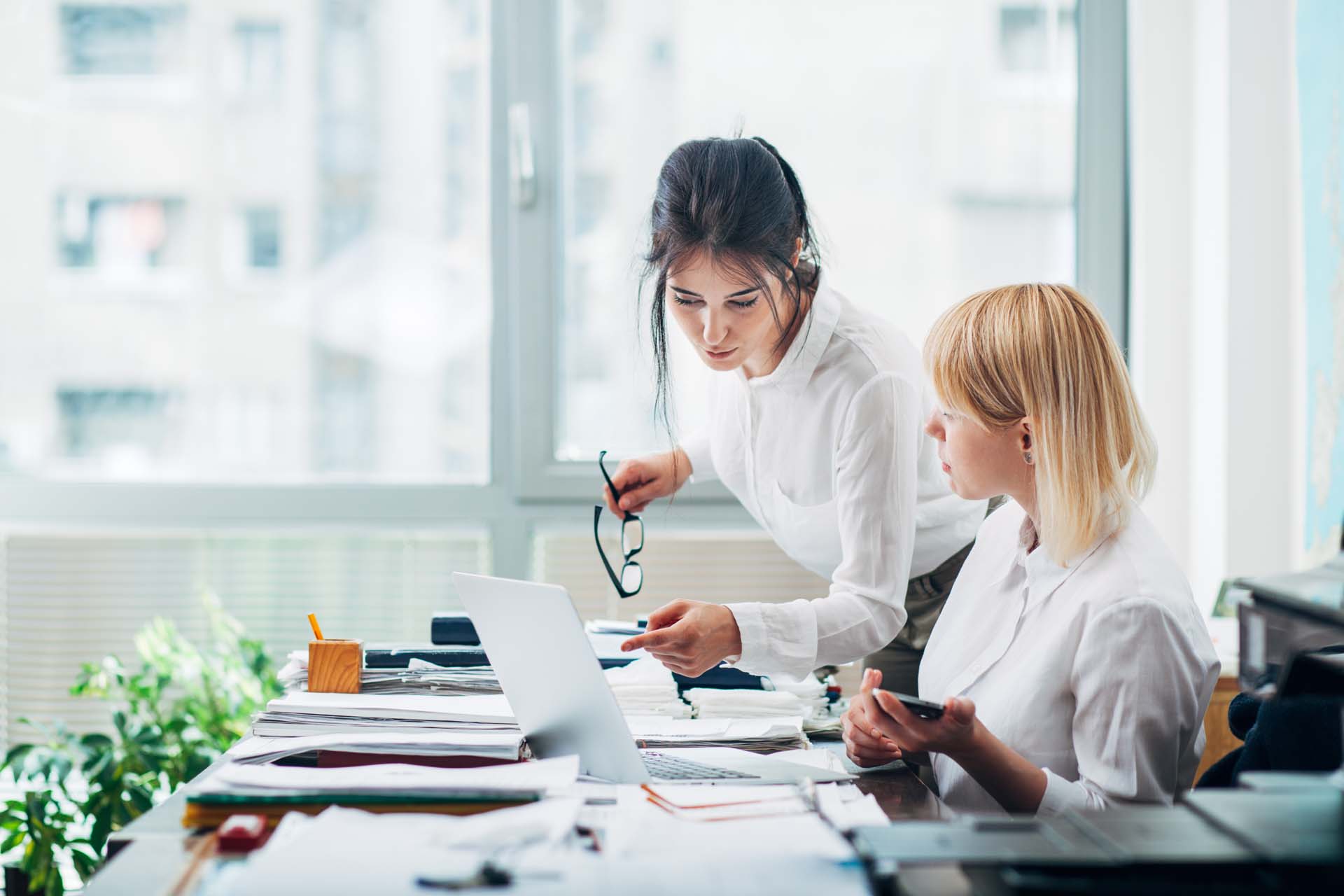 two women reviewing their lien portfolios