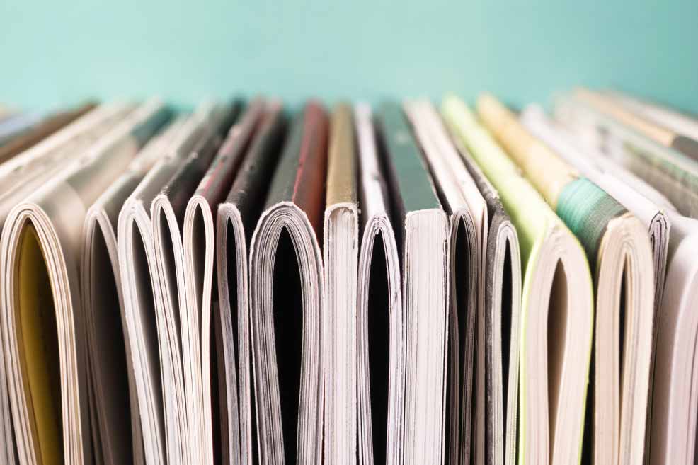 Stack of journals on their side, view of spines from the bottom