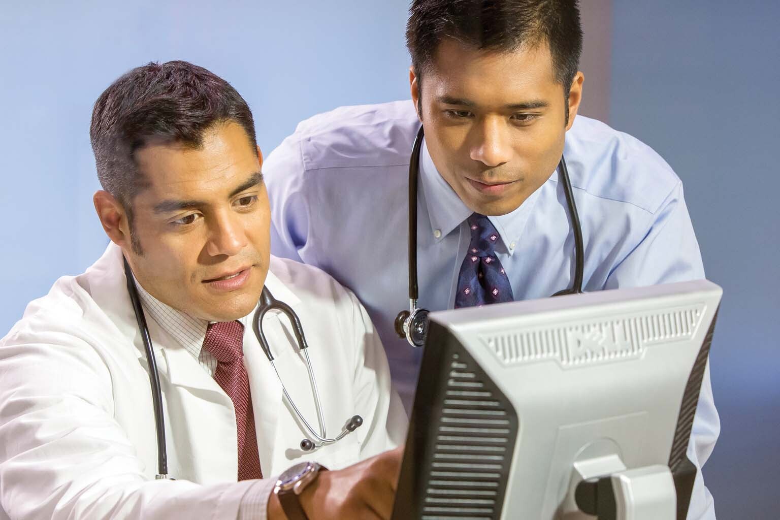 two clinicians at computer screen