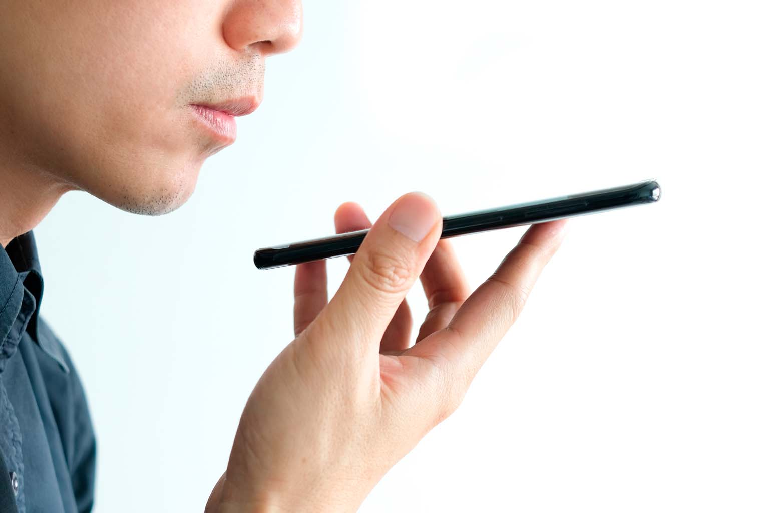 closeup of individual using voice recognition on smartphone