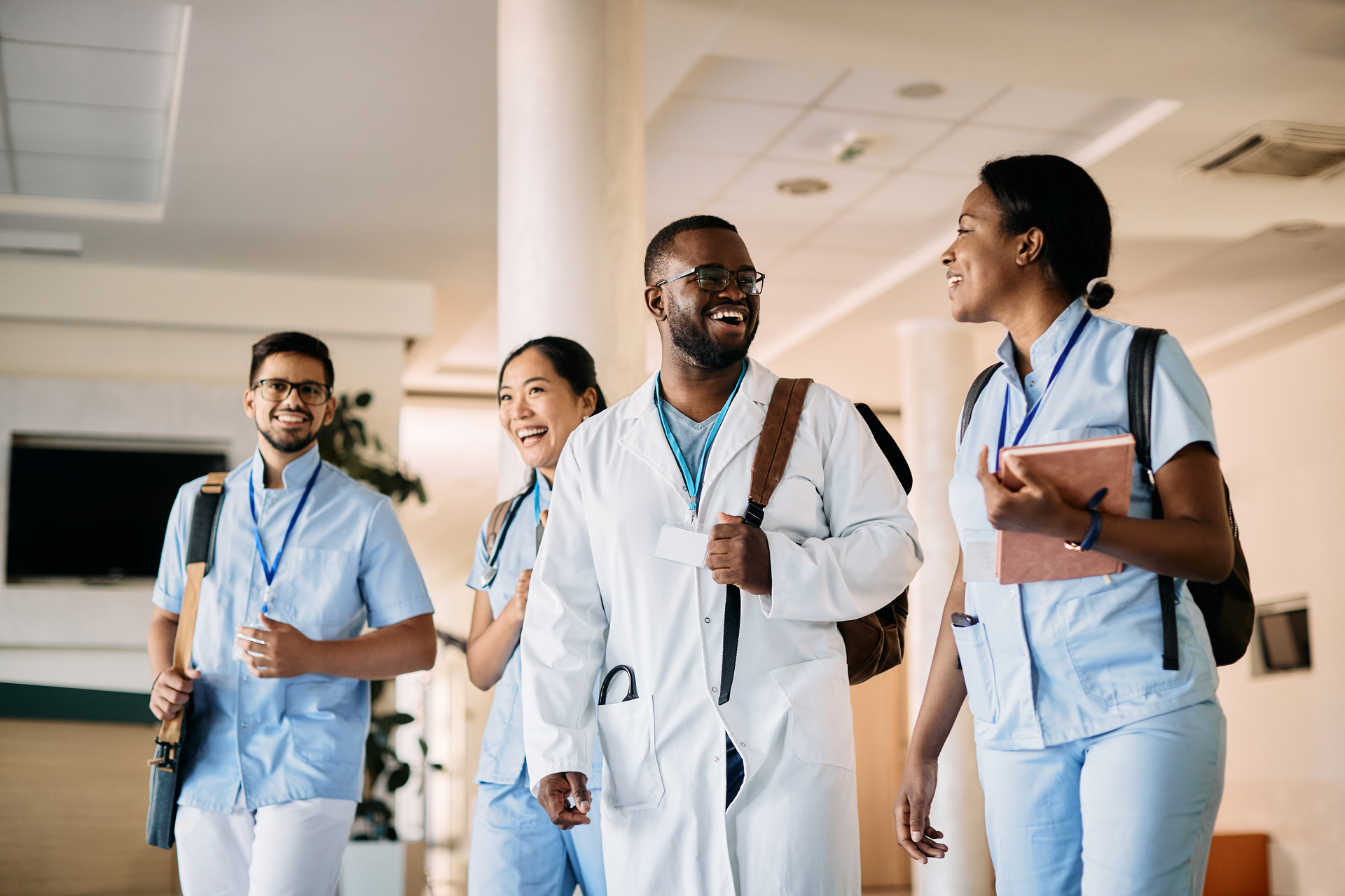 Happy smiling medical students talking while walking 