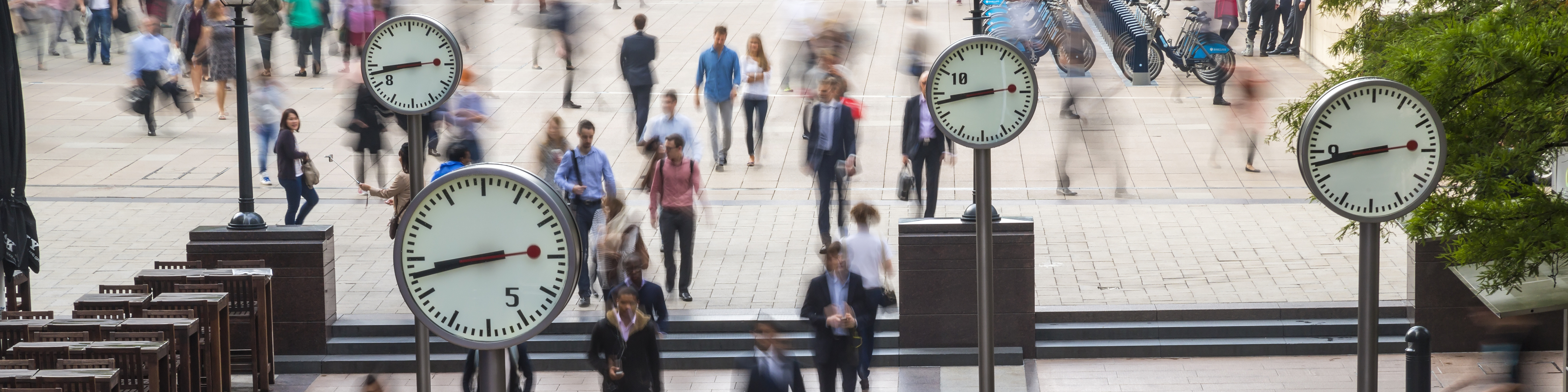 Clocks and commuters, Canary Wharf, London.