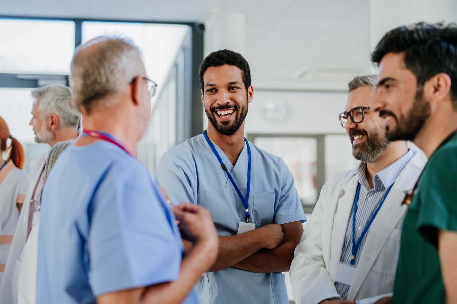 Group of doctors talking casually together in the hallway