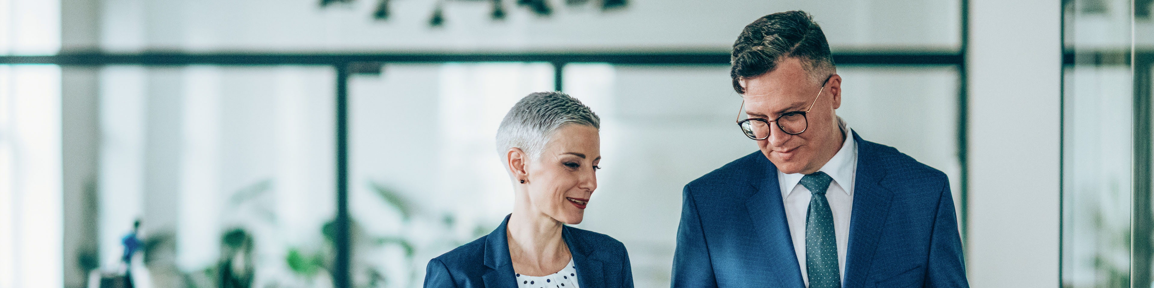 Shot of a businesswoman and businessman talking in the work place