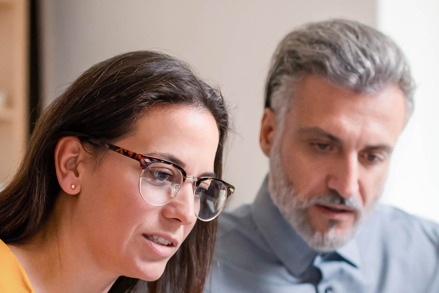 Two businesspeople sitting at a computer review the LLC next steps