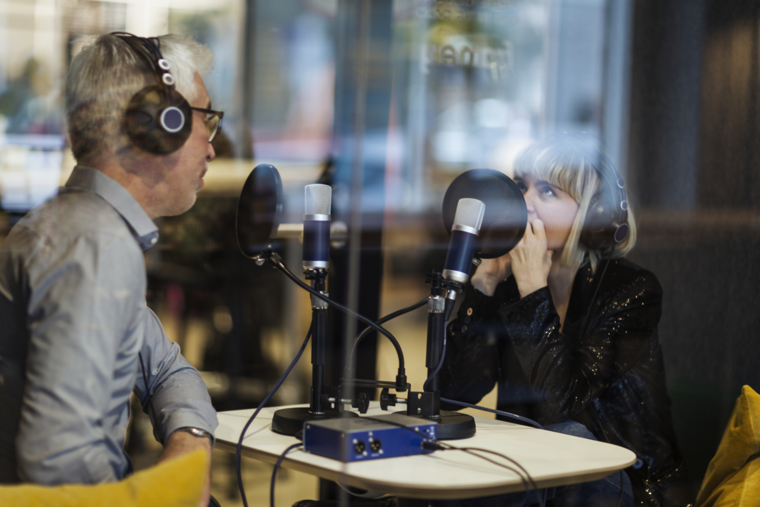 Employees recording a podcast in the office