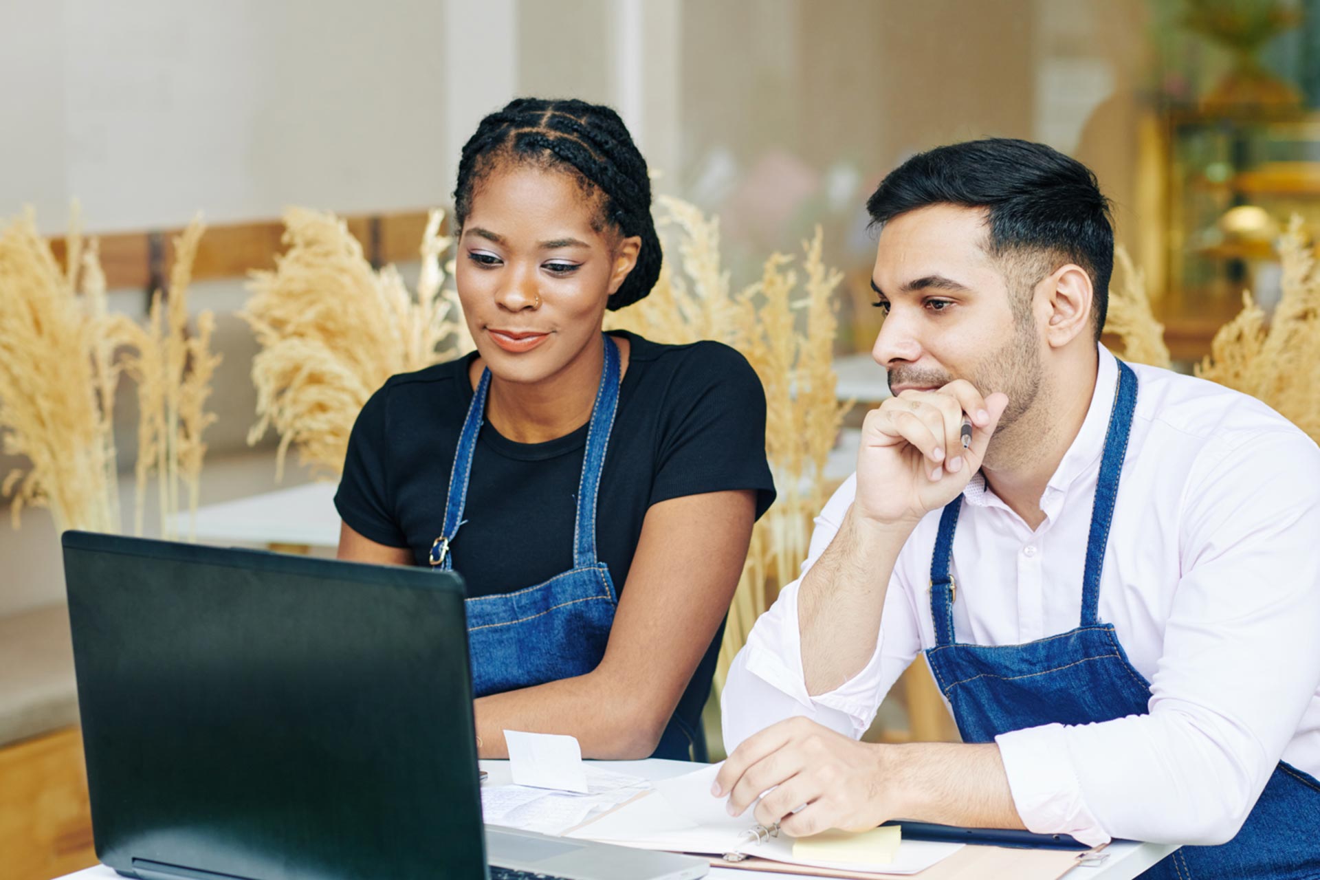 Couple getting a business license on a laptop