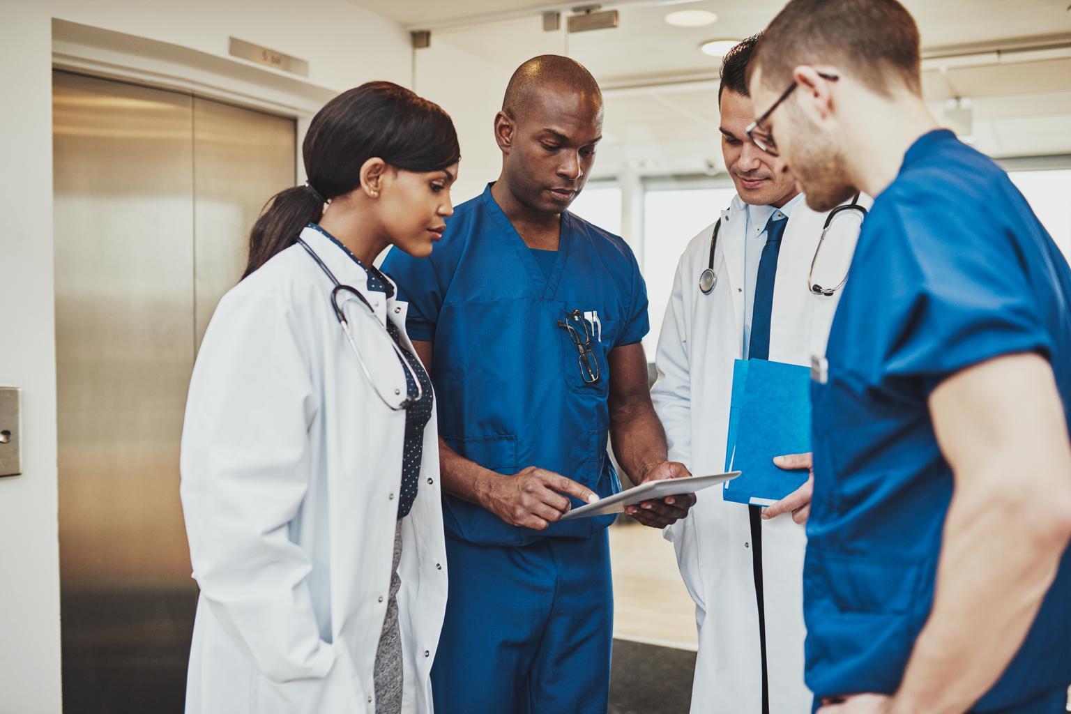 Group of doctors looking at information on a tablet