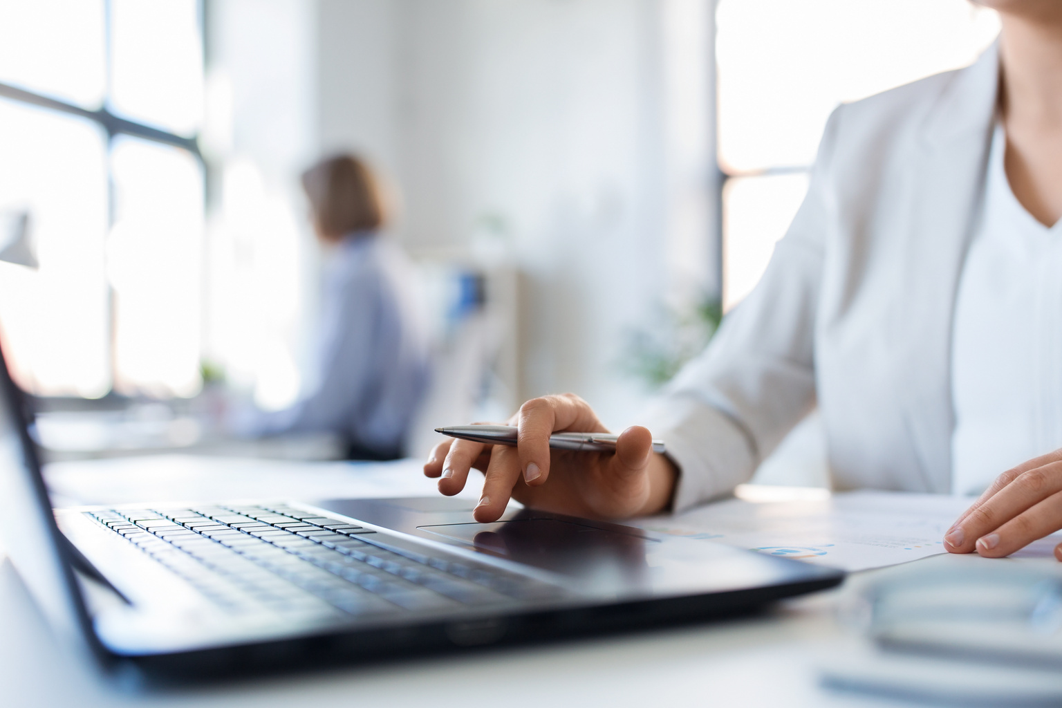 Close-up of woman in office on her laptop