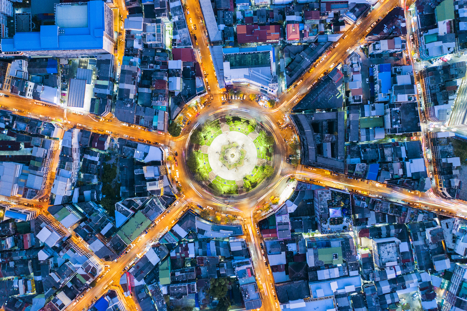 Aerial top view of roundabout of road with light trails,car lots on the road at night in Wongwainyai, Bangkok,Thailand, 