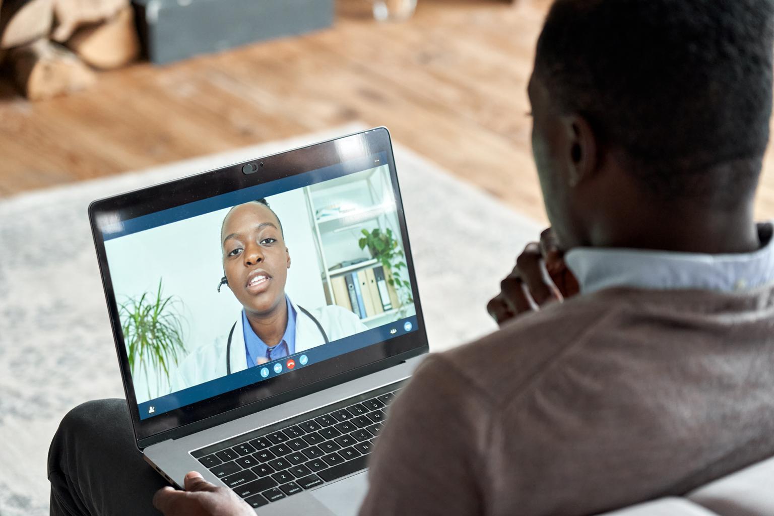 Black patient speaking with Black doctor over telehealth, virtual care