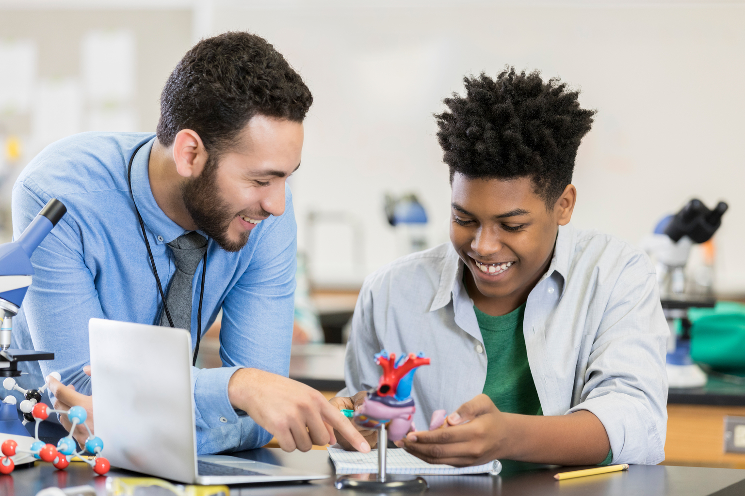 Teacher and student working together in classroom