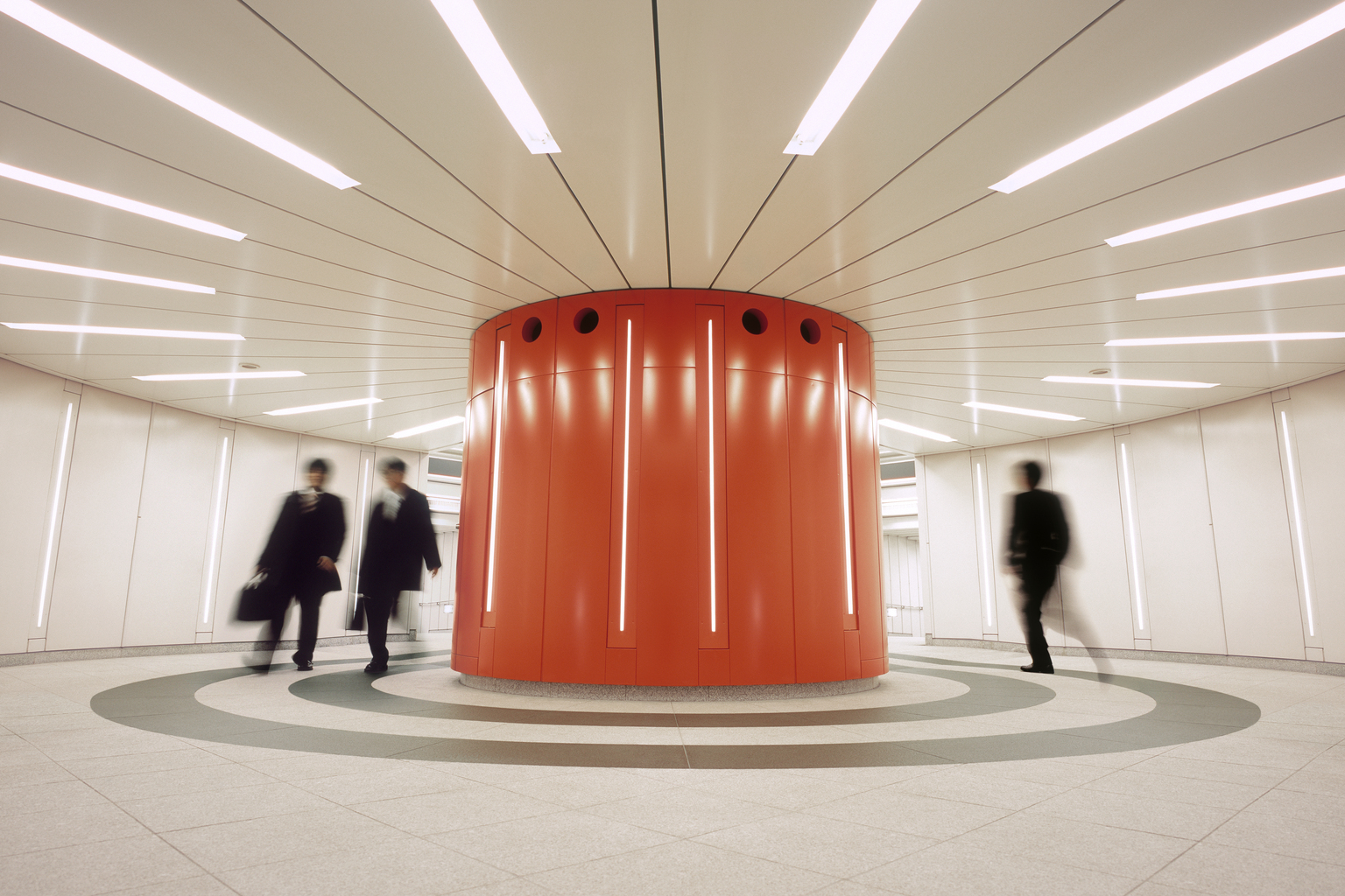 Businessmen crossing an underground underpass at a business district in Tokyo, Japan.