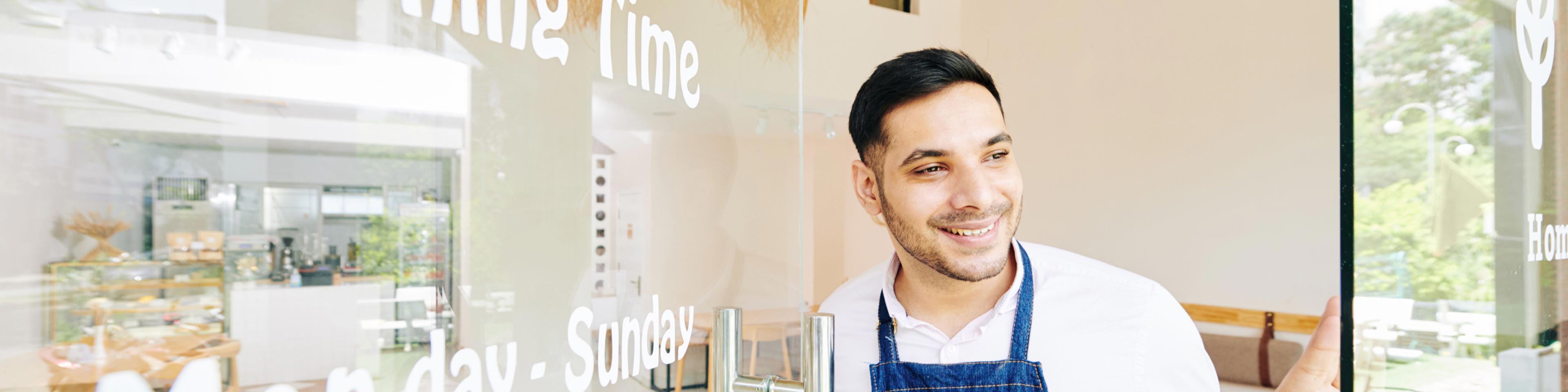 man with apron thinking about the benefits of starting a small business