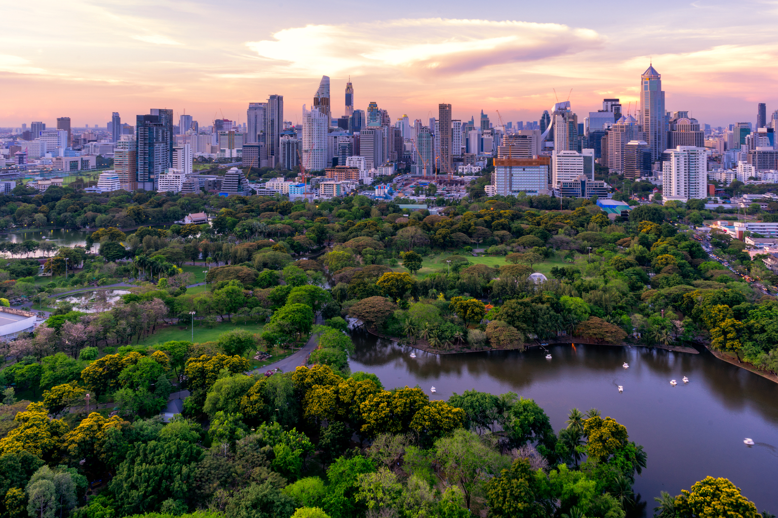 Sunset scence of Bangkok skyline Panorama ,Aerial view of Bangkok modern office buildings and condominium in Bangkok city downtown with sunset sky and clouds at Bangkok , Thailand. Lumpini park