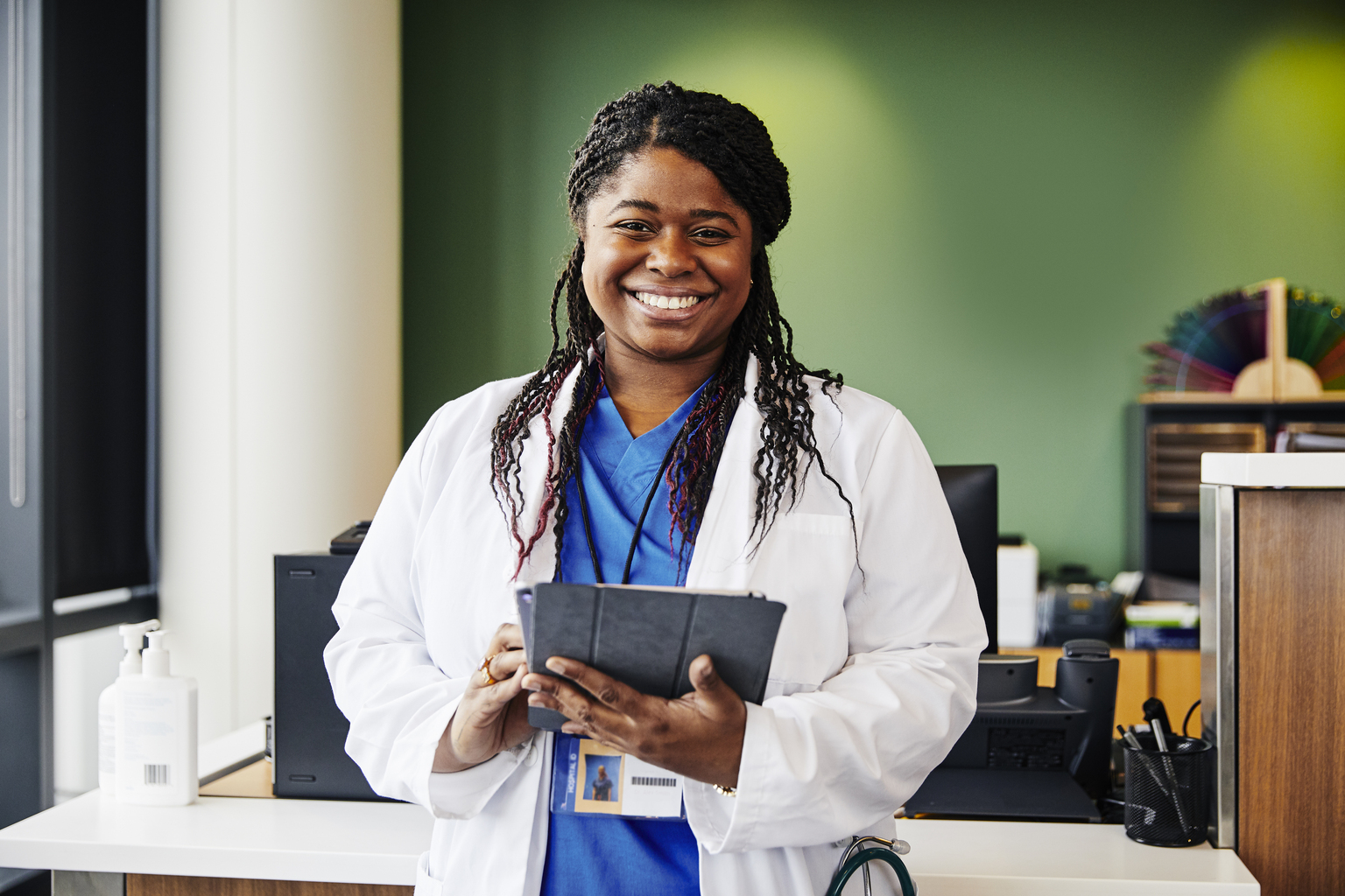 Portrait of confident young doctor holding digital tablet 