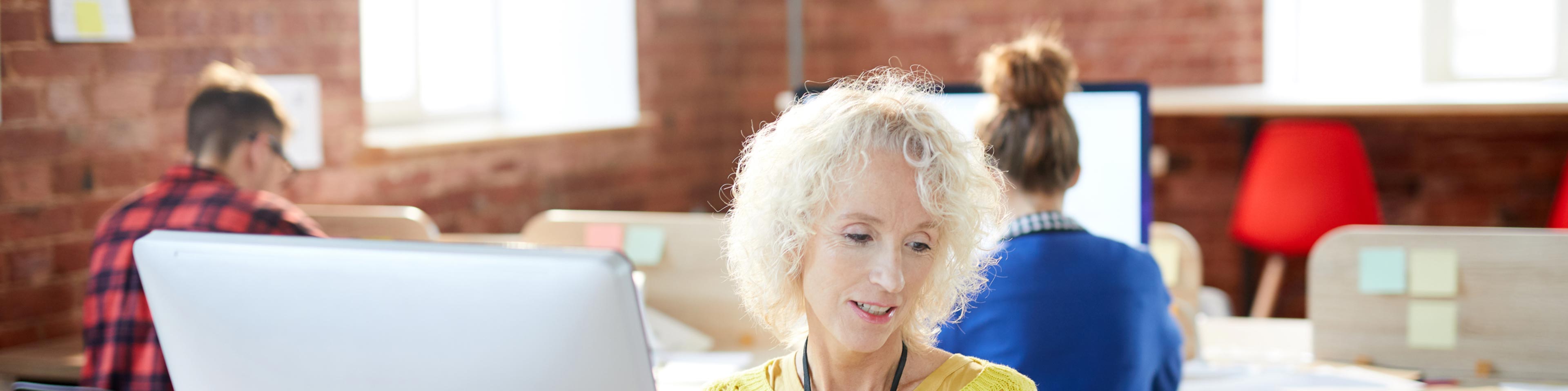 woman at laptop reviewing business ratios