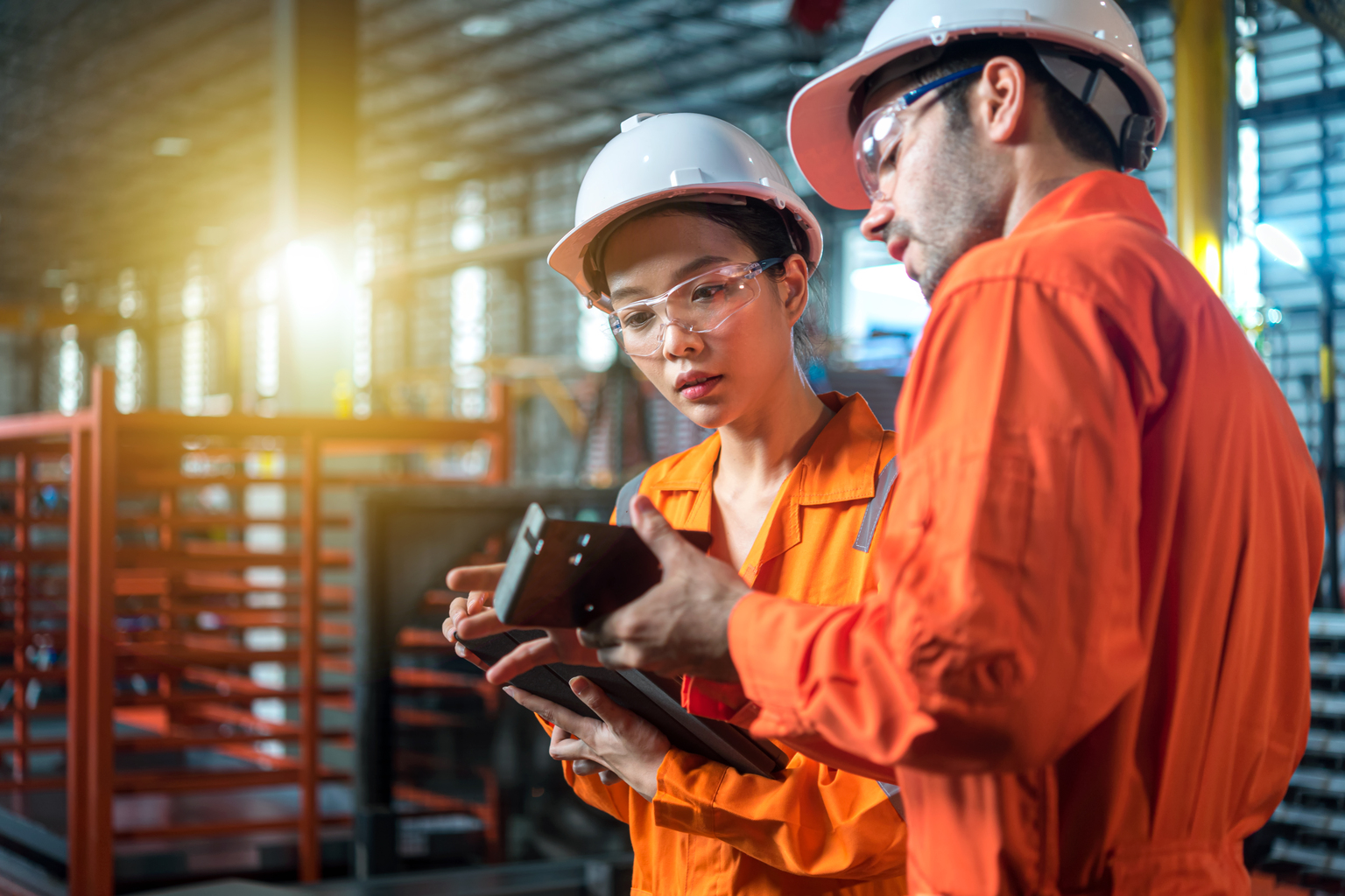 Male and female engineer are checking quality of product on hand