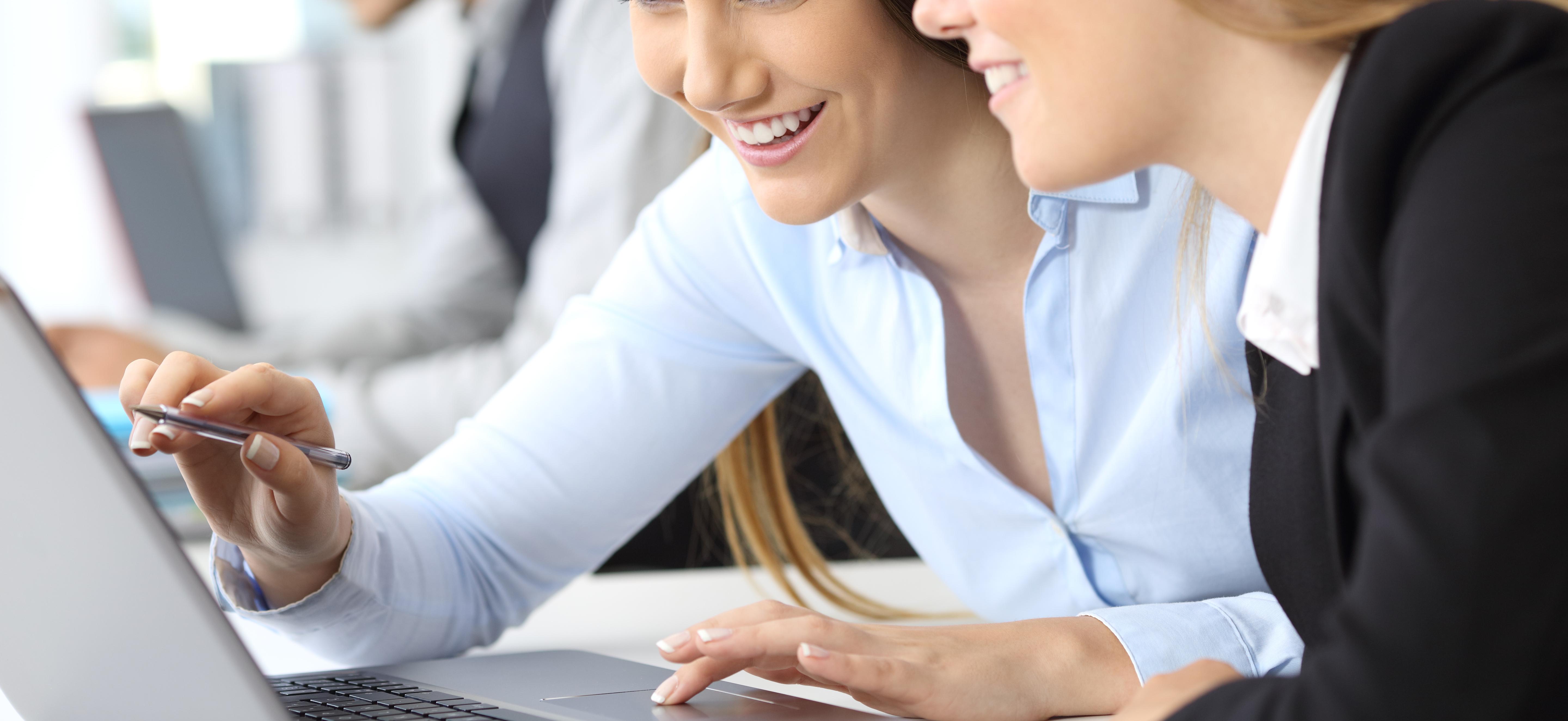 Businesswomen working together with a laptop