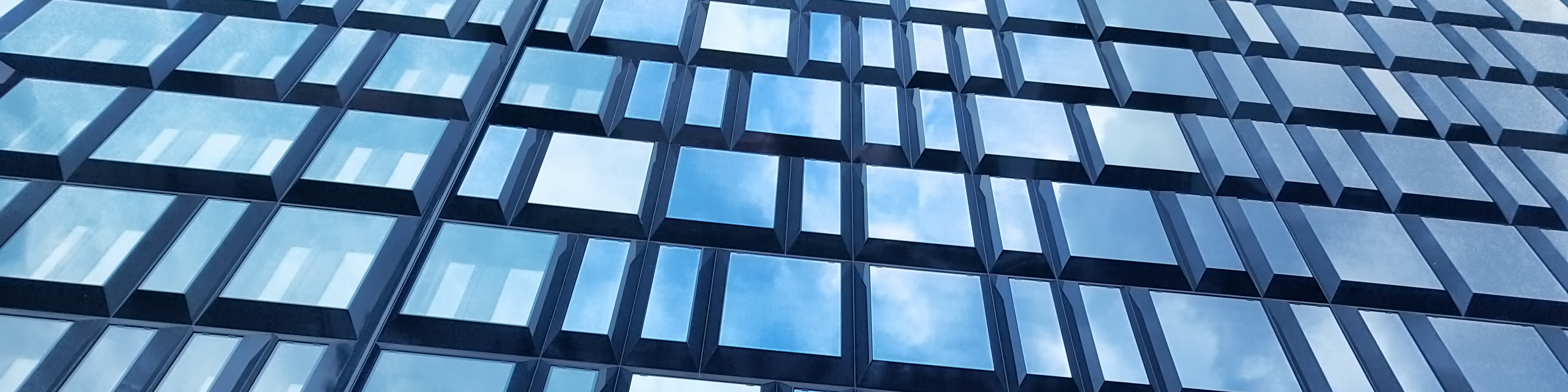 Modern glass facade of "The Corner", a new mixed-use building in the Porta Nuova district of Milan, Italy,