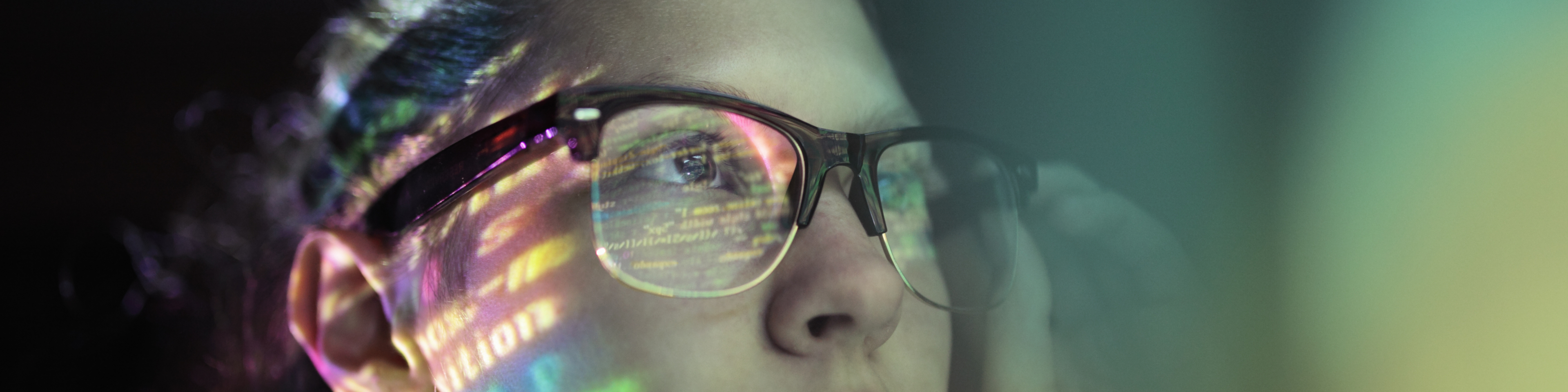 woman with brown glasses staring at code screen with the reflection hitting her glasses, Q3 2021, TAA NA US - Preparer