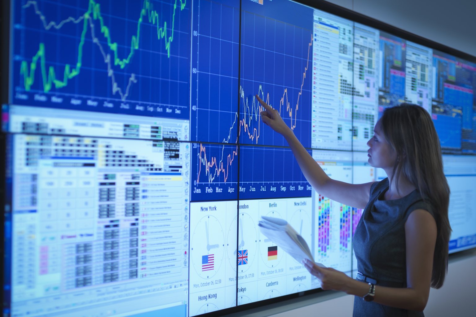 Businesswoman preparing presentation on graphical screens