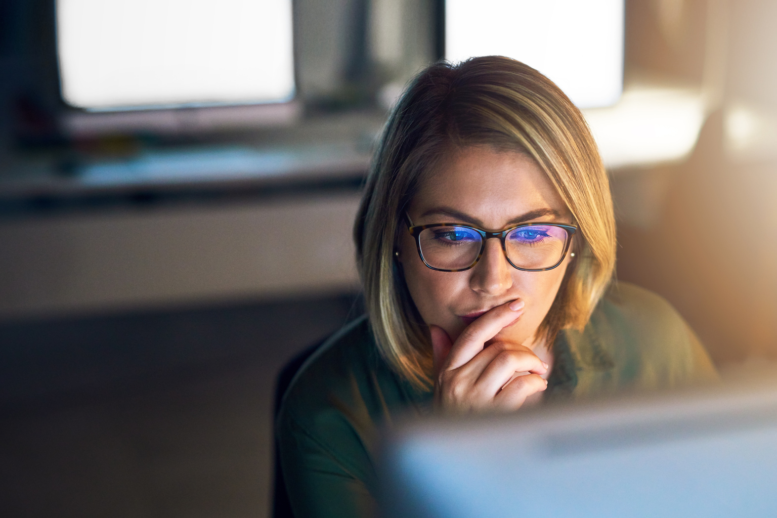 Woman with Laptop Reading and Thinking