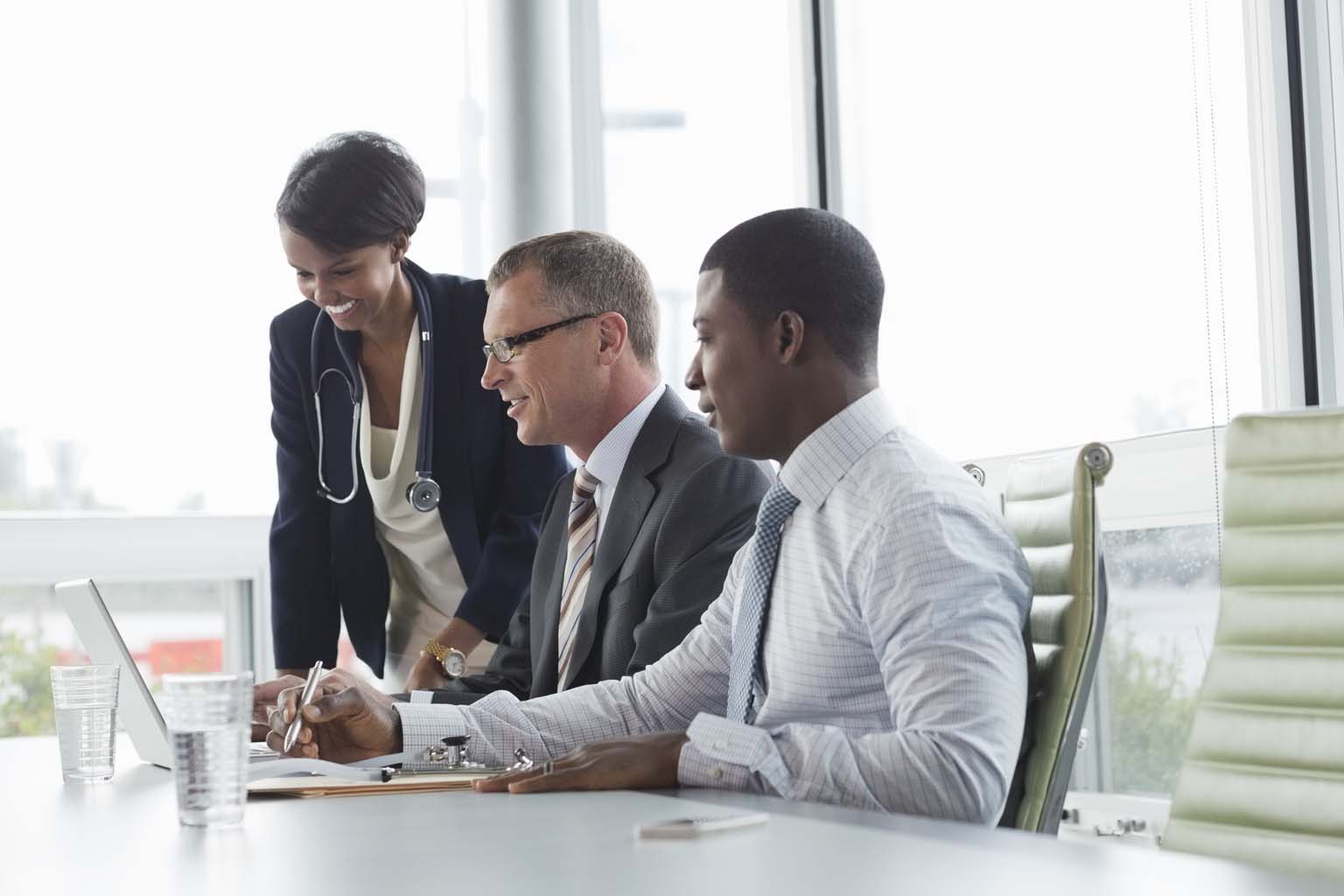 clinician and professionals collaborating in conference room